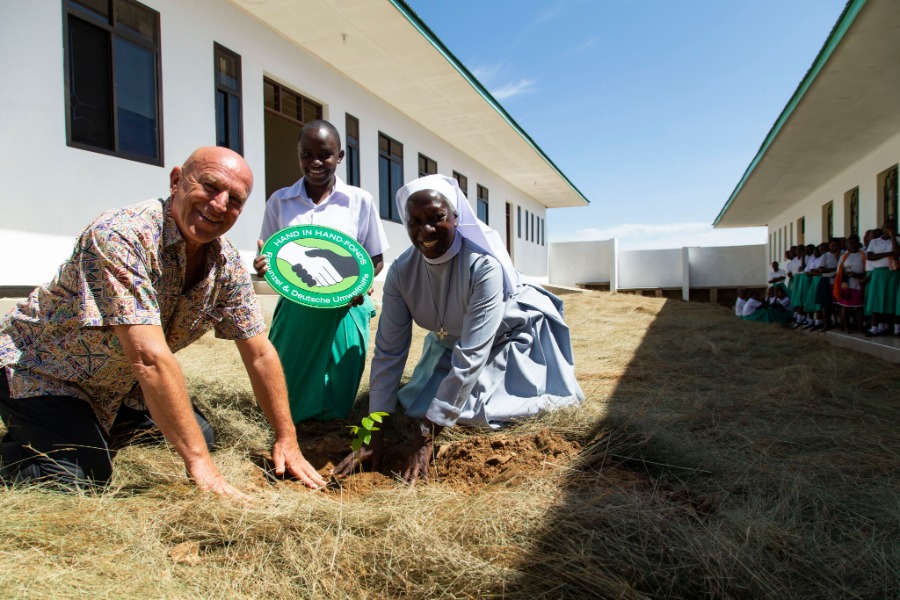 Joseph Wilhelm, founder and shareholder of Rapunzel, plants a tree at the opening of a dormitory at Hekima Girls’ Secondary School in Tanzania.