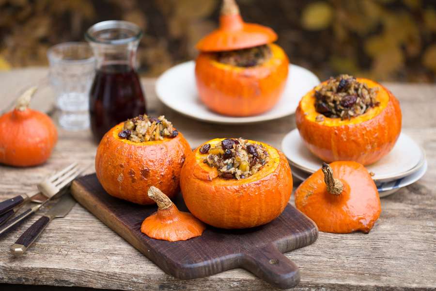 Roasted pumpkins stuffed with wild rice, pecan nuts and cranberries