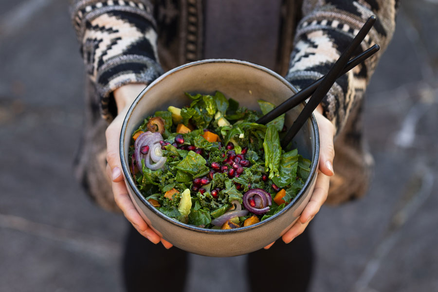 Kale salad with avocado, sweet potatoes and pomegranate