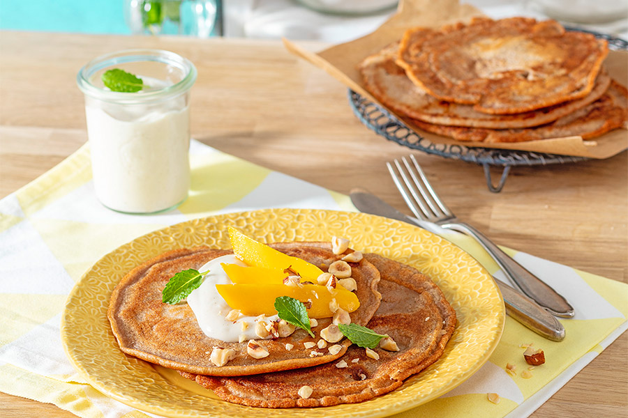Walnut pancakes with mango & quark cream