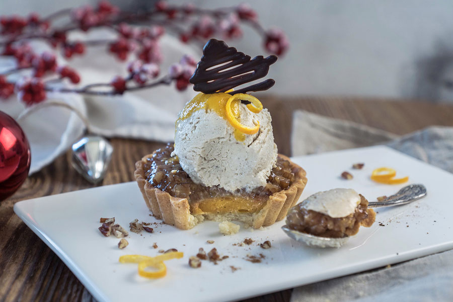 Pecan pie with spicy Christmas cookie ice cream and amaretto sauce