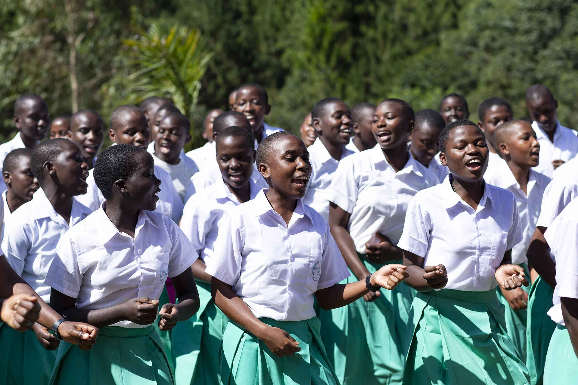 Durch die Hekima Girls´ School können Mädchen aus der Region zur Schule gehen. Strahlende und singende Mädchen auf ihrem Weg in die Mädchenschule.