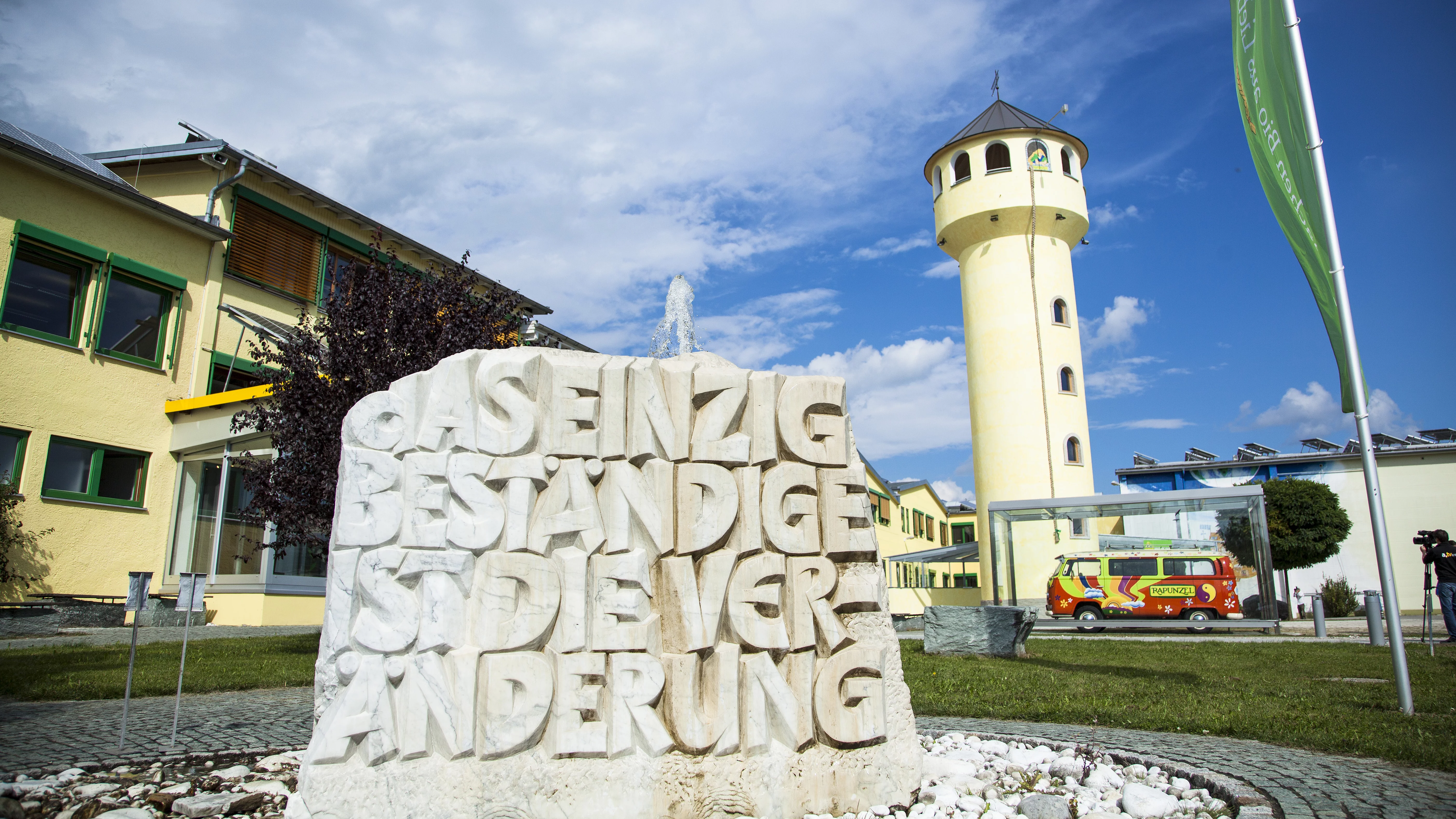 Stein mit der Schrift Das einzige beständige ist die Veränderung vor dem Firmengebäude in Legau. 