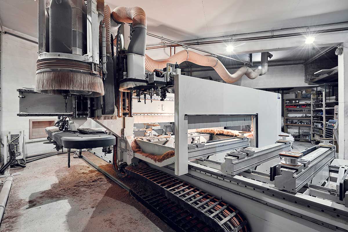 Von der Rückseite der Hokon-CNC-Fräse sieht man den großen Kettenwerkzeugwechsler und drei Bearbeitungsaggregate.