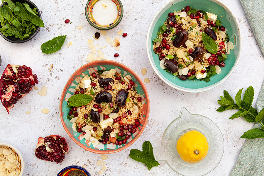 Couscous salad with colored giant beans and pomegranate