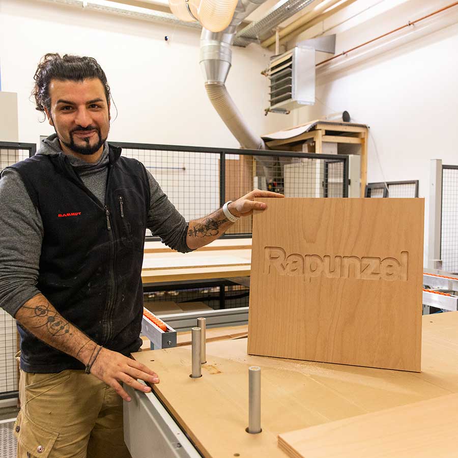 In a matter of seconds, the CNC machine has milled the 'Rapunzel' logo into the wood.