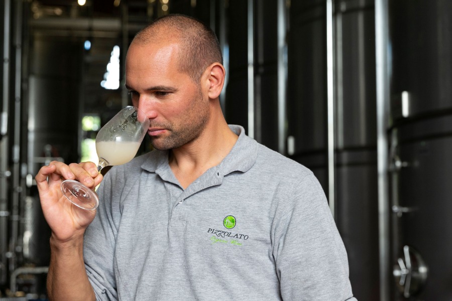 Oenologist Luca Zamai checks the quality of the maturing wines